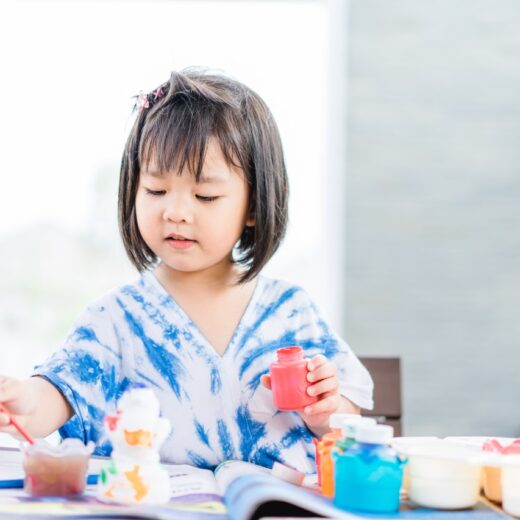 Little girl painting.